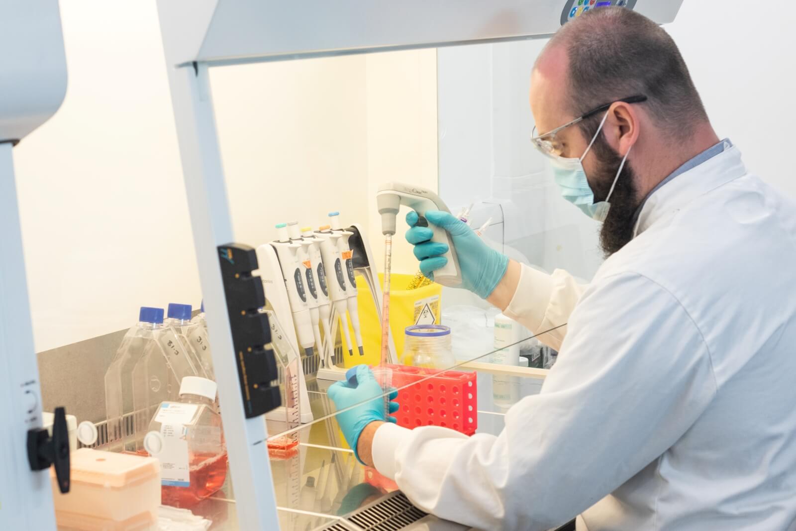 A scientist wearing a face mask