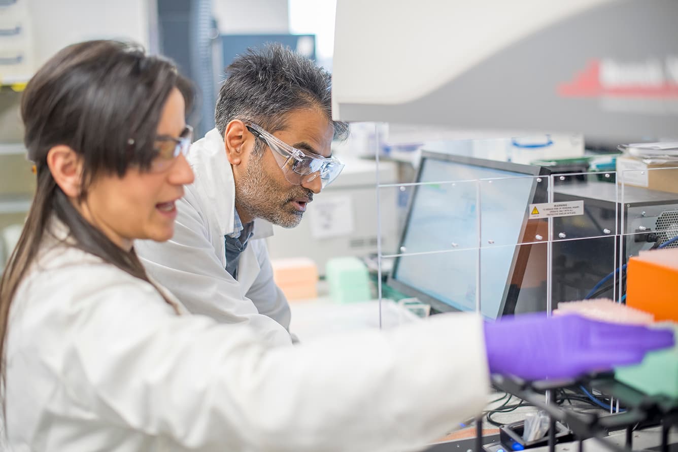 Scientists working in a laboratory setting with advanced equipment, representing collaborative biologics discovery and tailored strategies for antibody, peptide, and gene therapy development.
