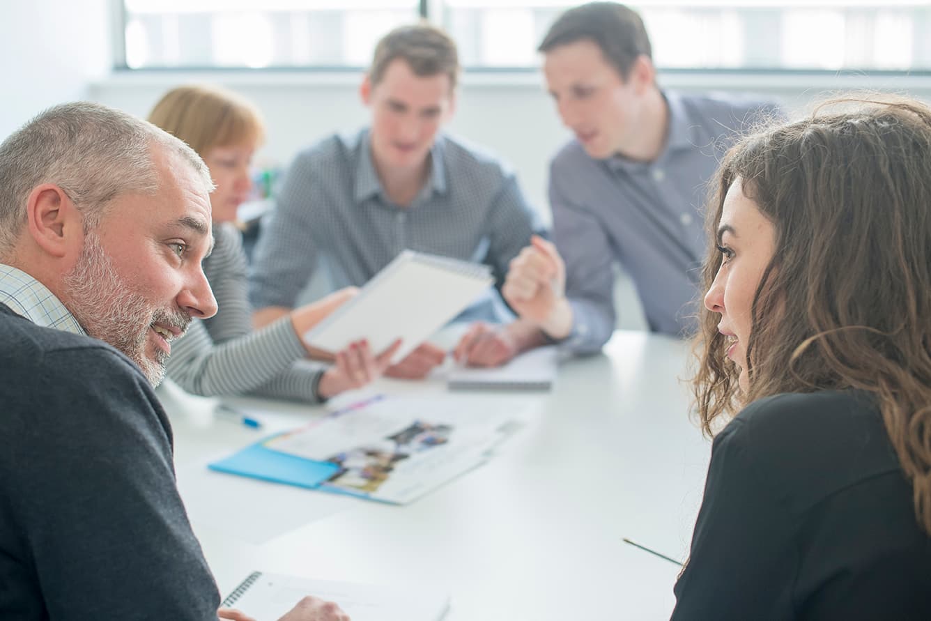 Team collaborating in a meeting room, representing strategic planning and partnership in biologics discovery and development.