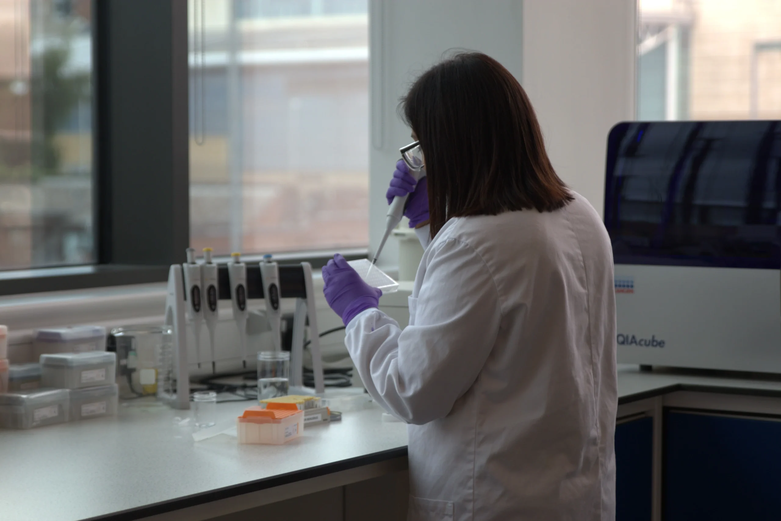 Laboratory environment showing assay preparation for bioscience research, representing tailored solutions to accelerate drug discovery programs
