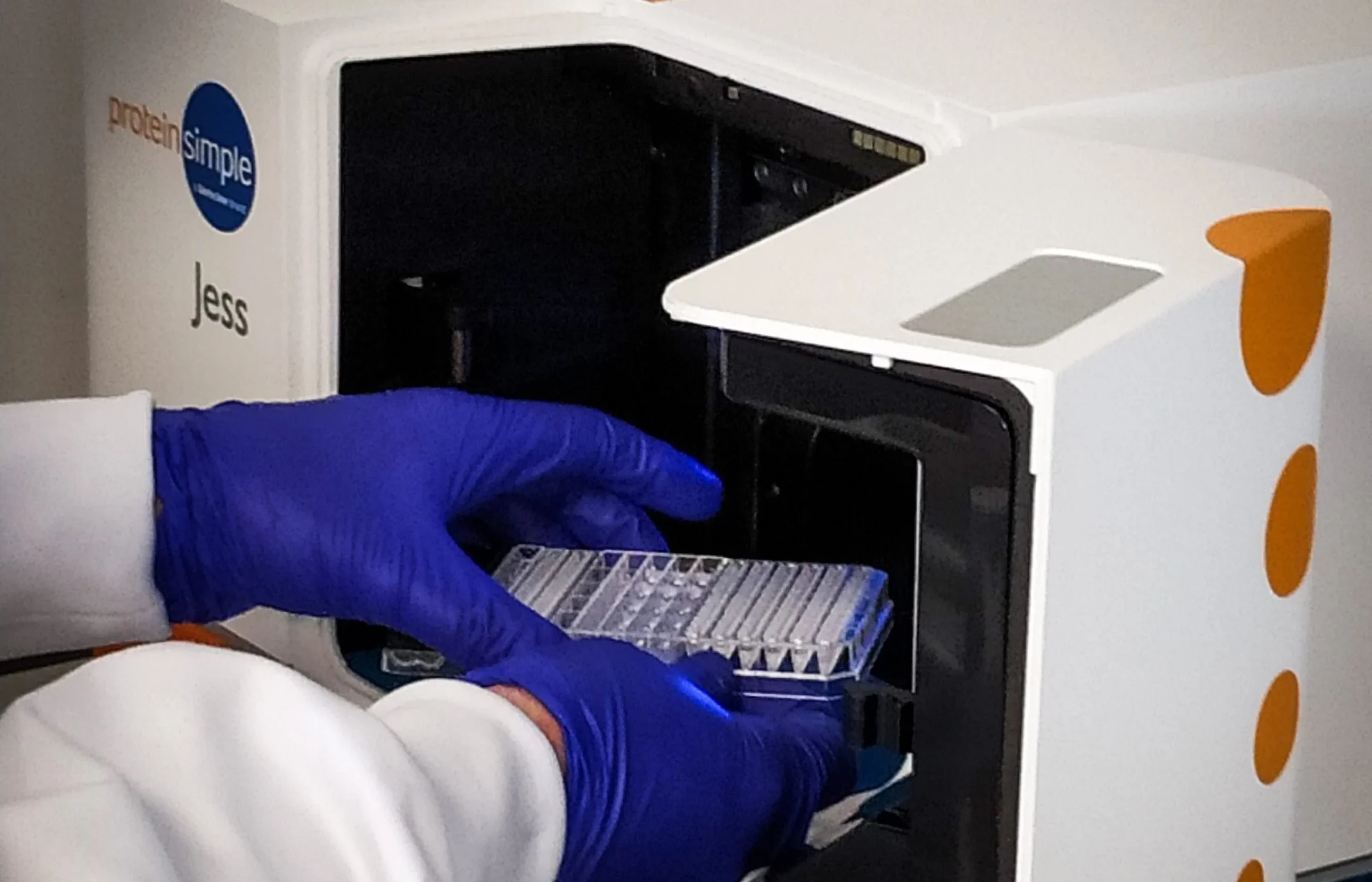 Laboratory automation system handling microplates, symbolizing gene and protein expression workflows for biopharmaceutical research.