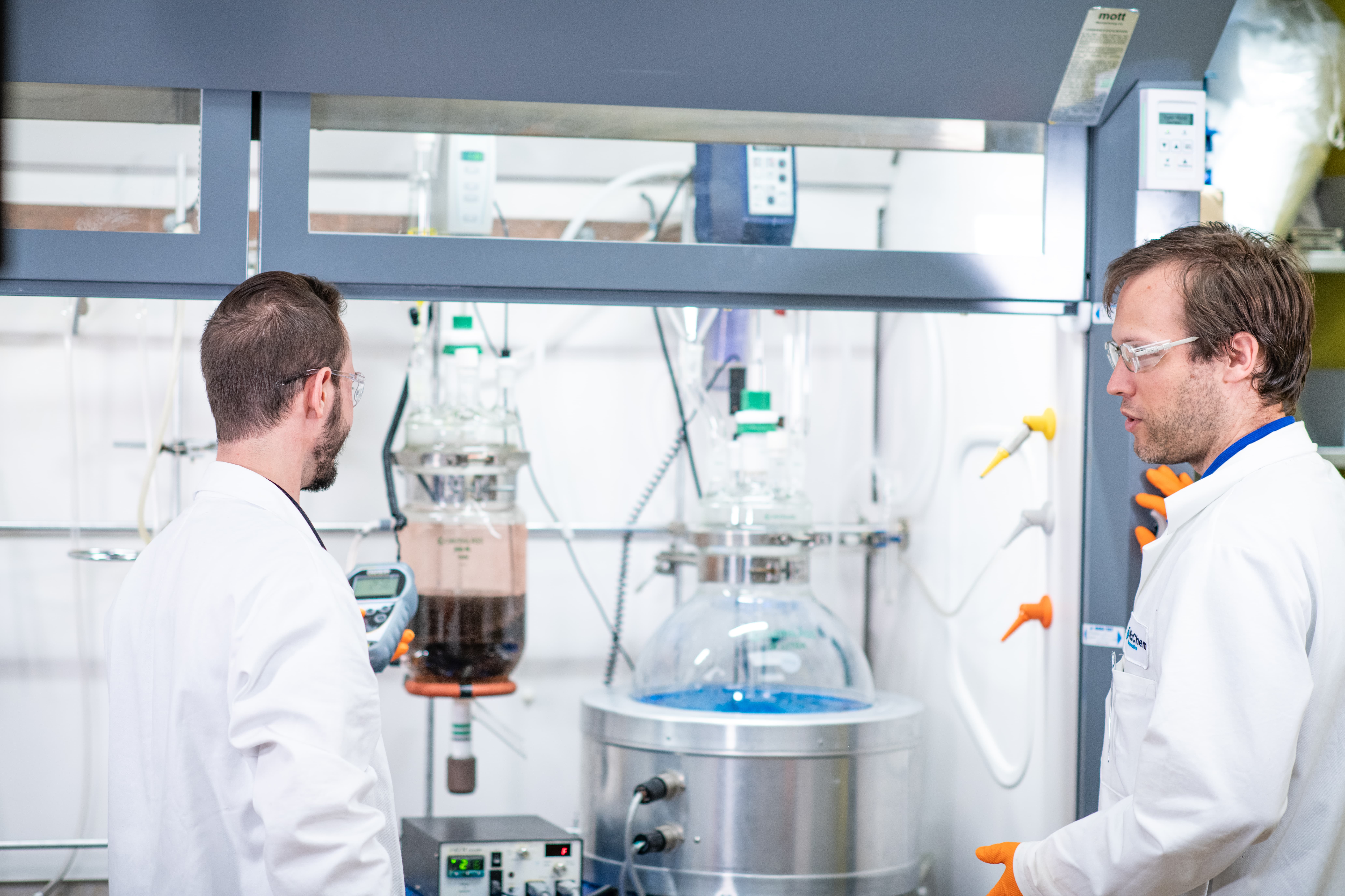Laboratory setup with large-scale reactors and process equipment, representing scale-up chemistry for route design, optimization, and manufacturing readiness.