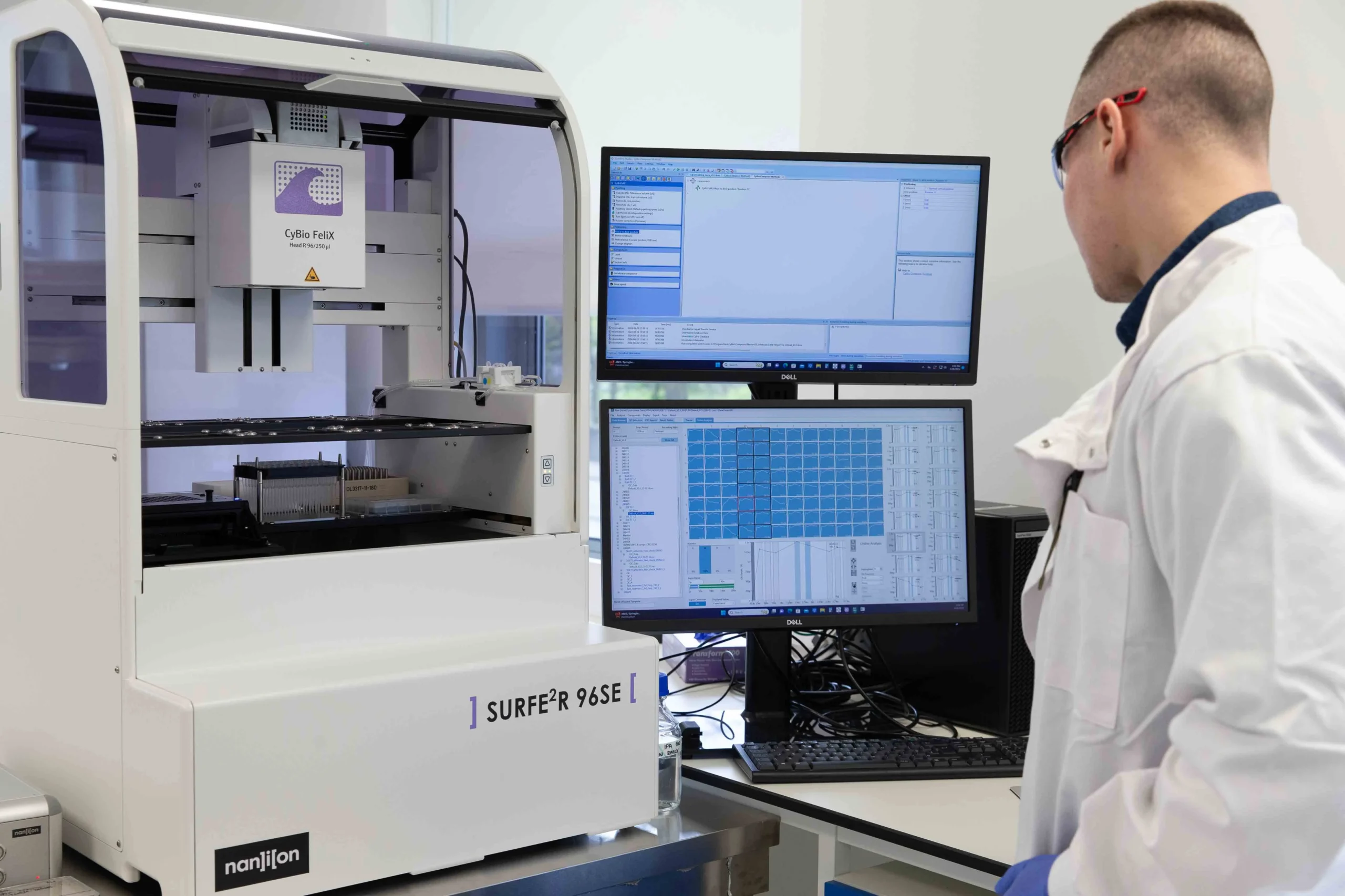 Laboratory setup with automated electrophysiology equipment and computer interface, representing custom study design for drug discovery including plate plans, screening cascades, and tailored protocols.