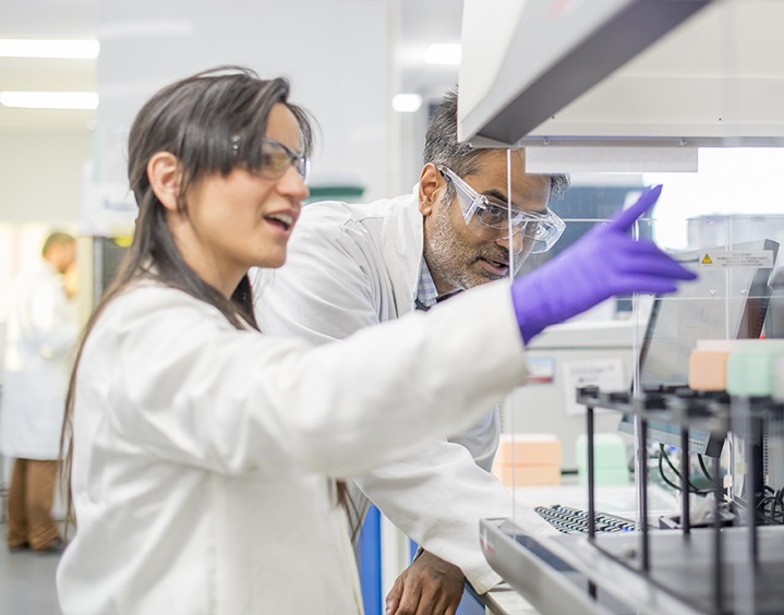 scientist pointing at equipment